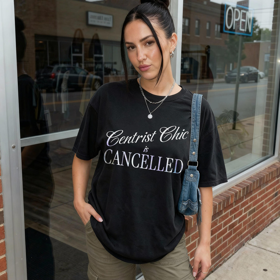 Woman wearing a black t-shirt with white text that reads &amp;quot;Centrist Chic is Cancelled.&amp;quot;
