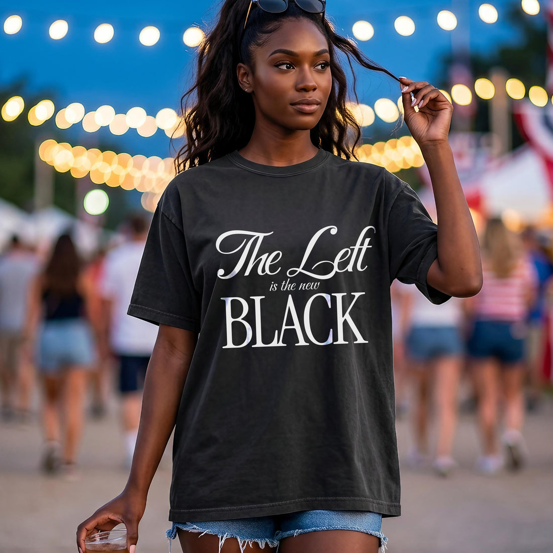 Dark t-shirt with white text &amp;quot;The Left is the new BLACK&amp;quot; on a woman outdoors.