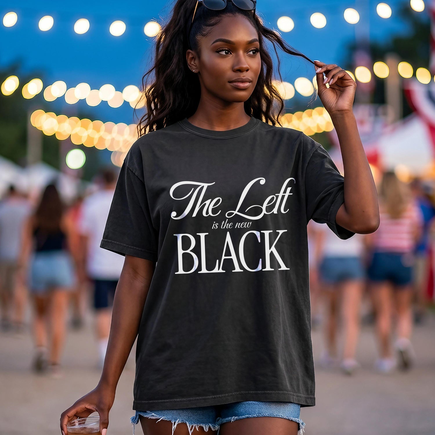 Dark t-shirt with white text &amp;quot;The Left is the new BLACK&amp;quot; on a woman outdoors.