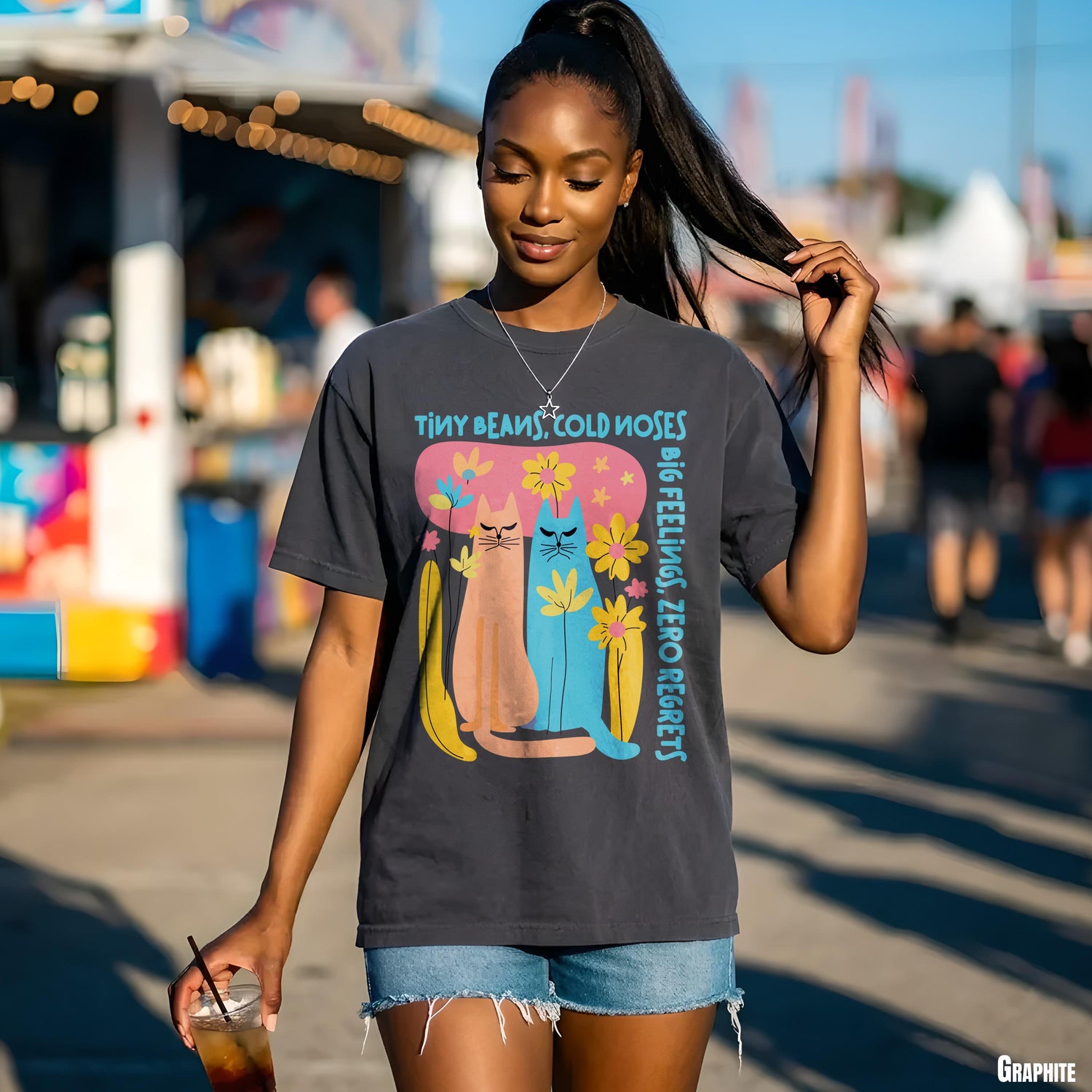 Dark grey t-shirt with cartoon cats and flowers, reading &amp;quot;BIG FEELINGS, ZERO REGRETS&amp;quot;.