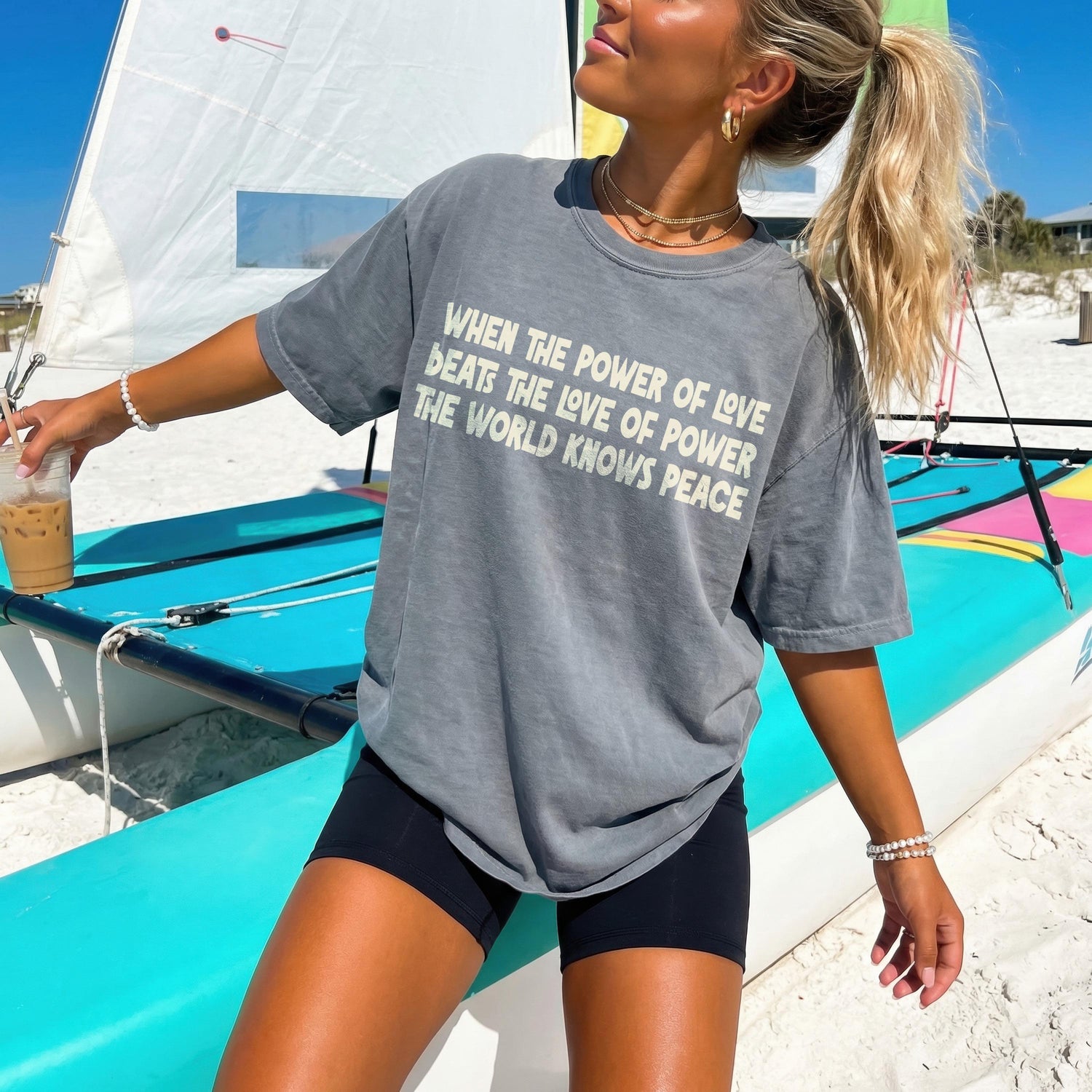 Gray t-shirt with white text &amp;quot;When the power of love beats the love of power the world knows peace&amp;quot;.