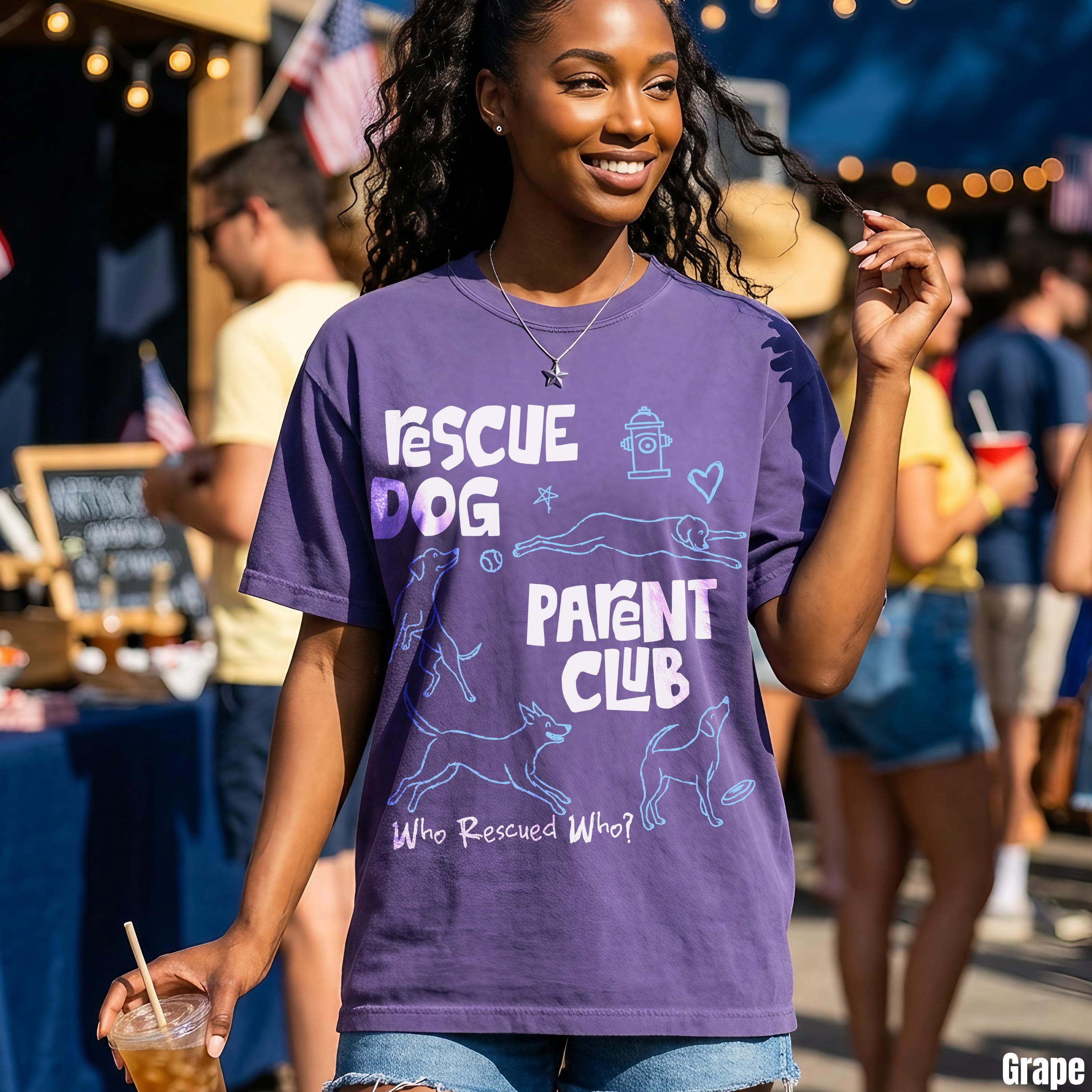Purple t-shirt with &amp;quot;Rescue Dog Parent Club&amp;quot; text and dog-related graphics.