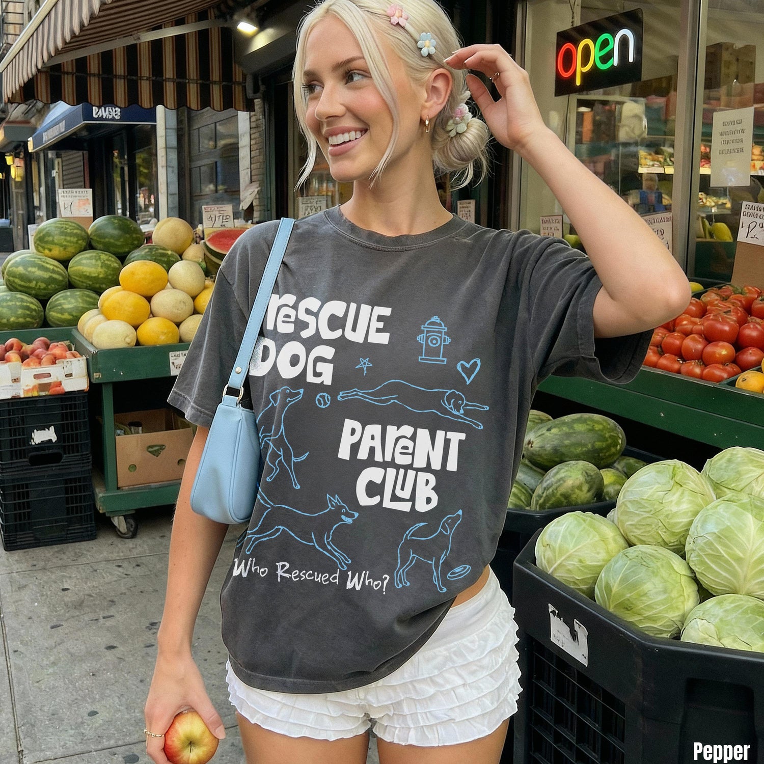 Woman wearing graphic t-shirt with &amp;quot;RESCUE DOG PARENT CLUB&amp;quot; text and dog illustrations.