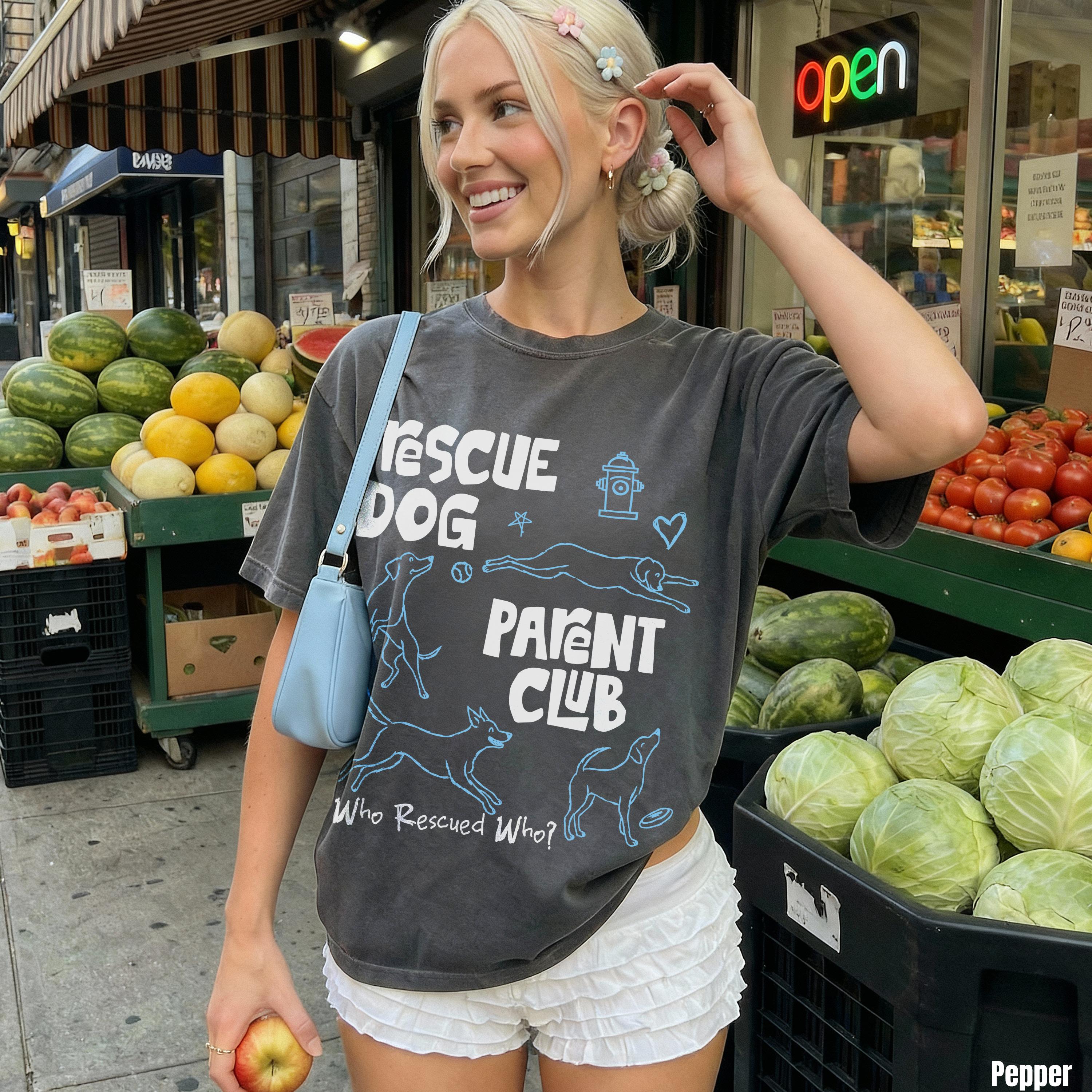Woman wearing graphic t-shirt with &amp;quot;RESCUE DOG PARENT CLUB&amp;quot; text and dog illustrations.