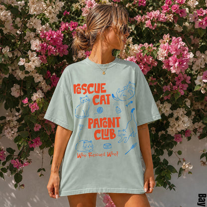 Light blue t-shirt with cartoon cats and &amp;quot;Rescue Cat Who Rescued Who?&amp;quot; text.