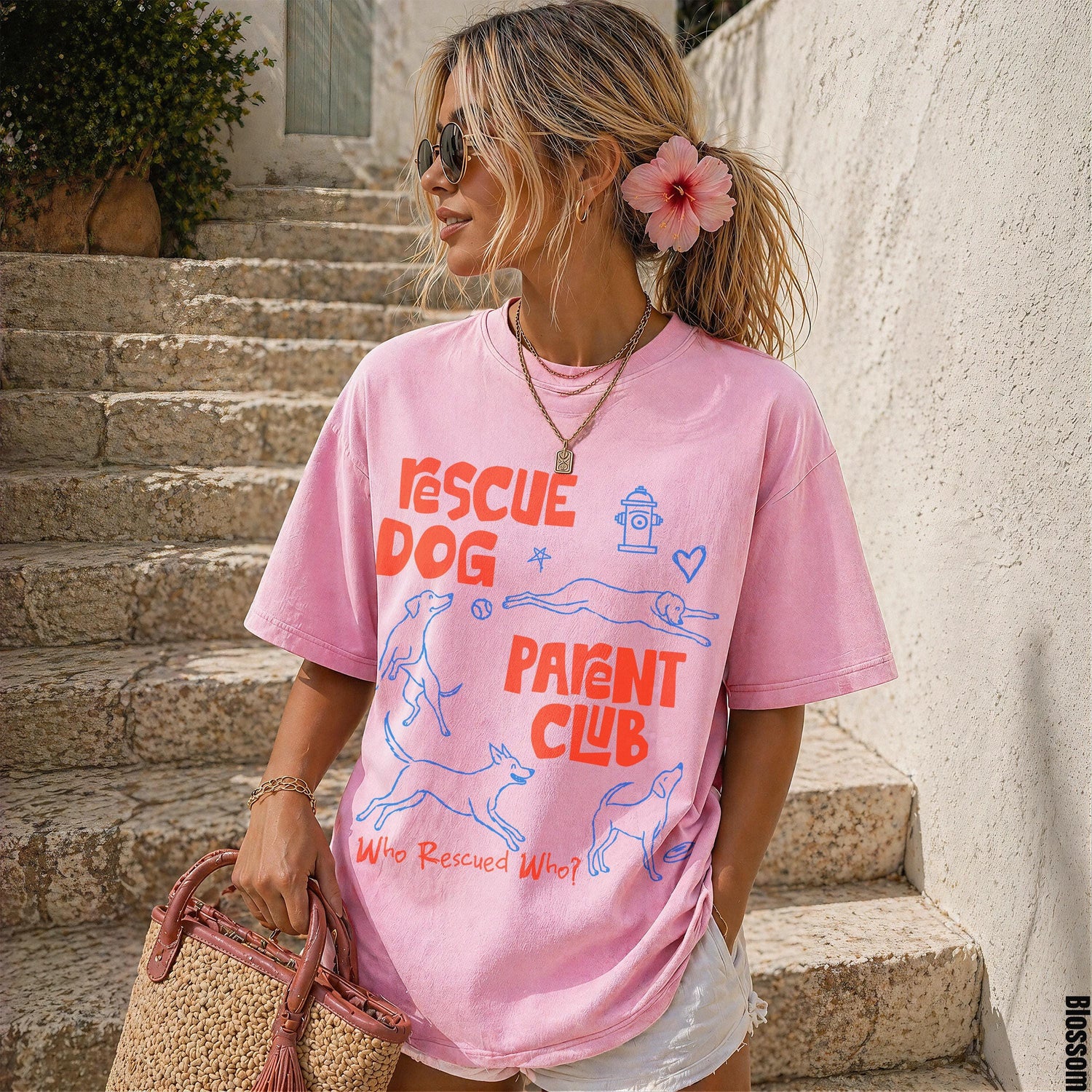 Pink t-shirt with &amp;quot;Rescue Dog Parent Club&amp;quot; graphic and dog illustrations.
