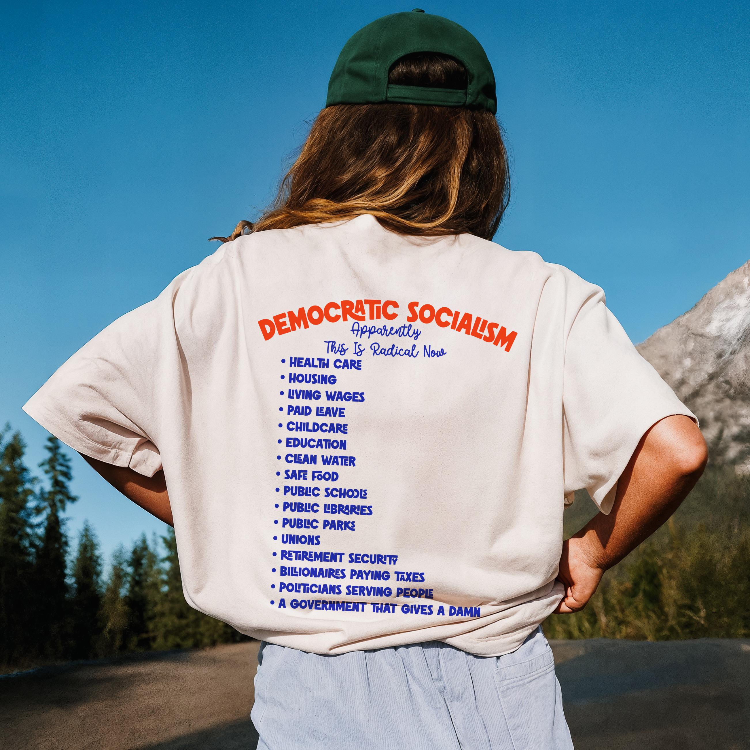 T-shirt with &amp;quot;Democratic Socialism Apparently This Is Radical Now&amp;quot; and a list of policies in blue text.