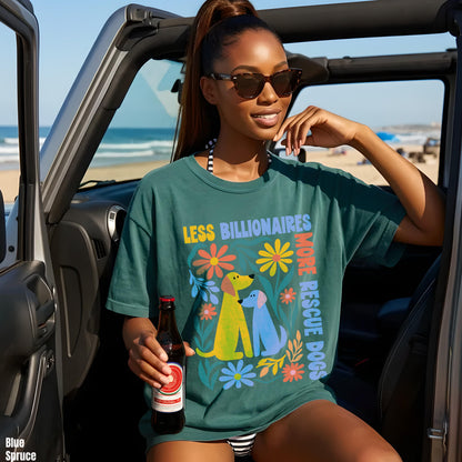 Woman in teal t-shirt with &amp;quot;Less Billionaires More Rescue Dogs&amp;quot; text and floral graphic.