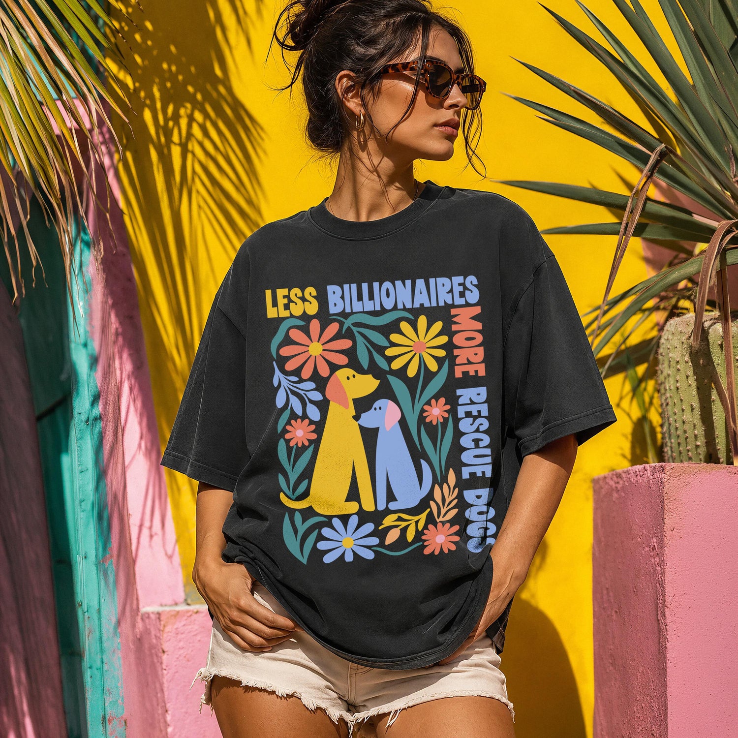 Black t-shirt with colorful floral and dog graphic and text.