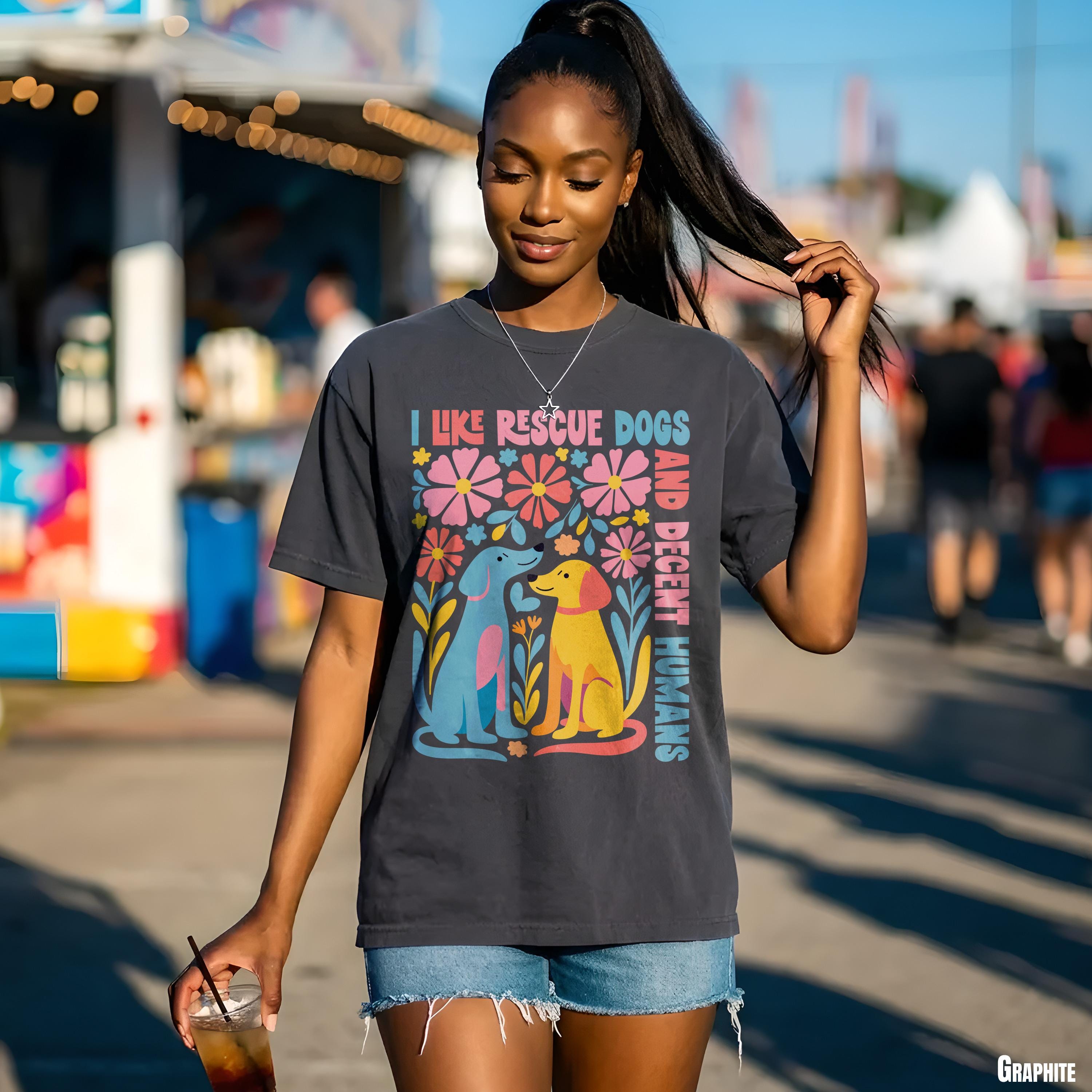 T-shirt with &amp;quot;I like rescue dogs and decent humans&amp;quot; text and colorful dog illustration.