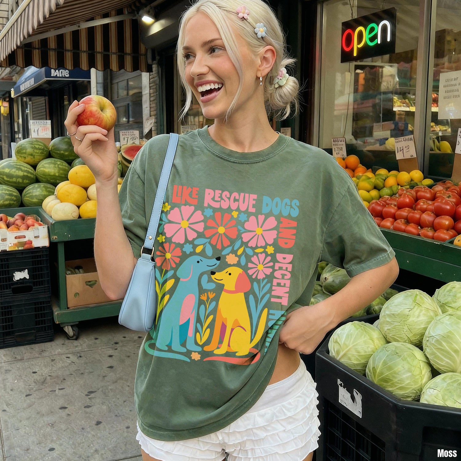 Green t-shirt with &amp;quot;Like Rescue Dogs, Be Decent&amp;quot; text and colorful dog graphics.