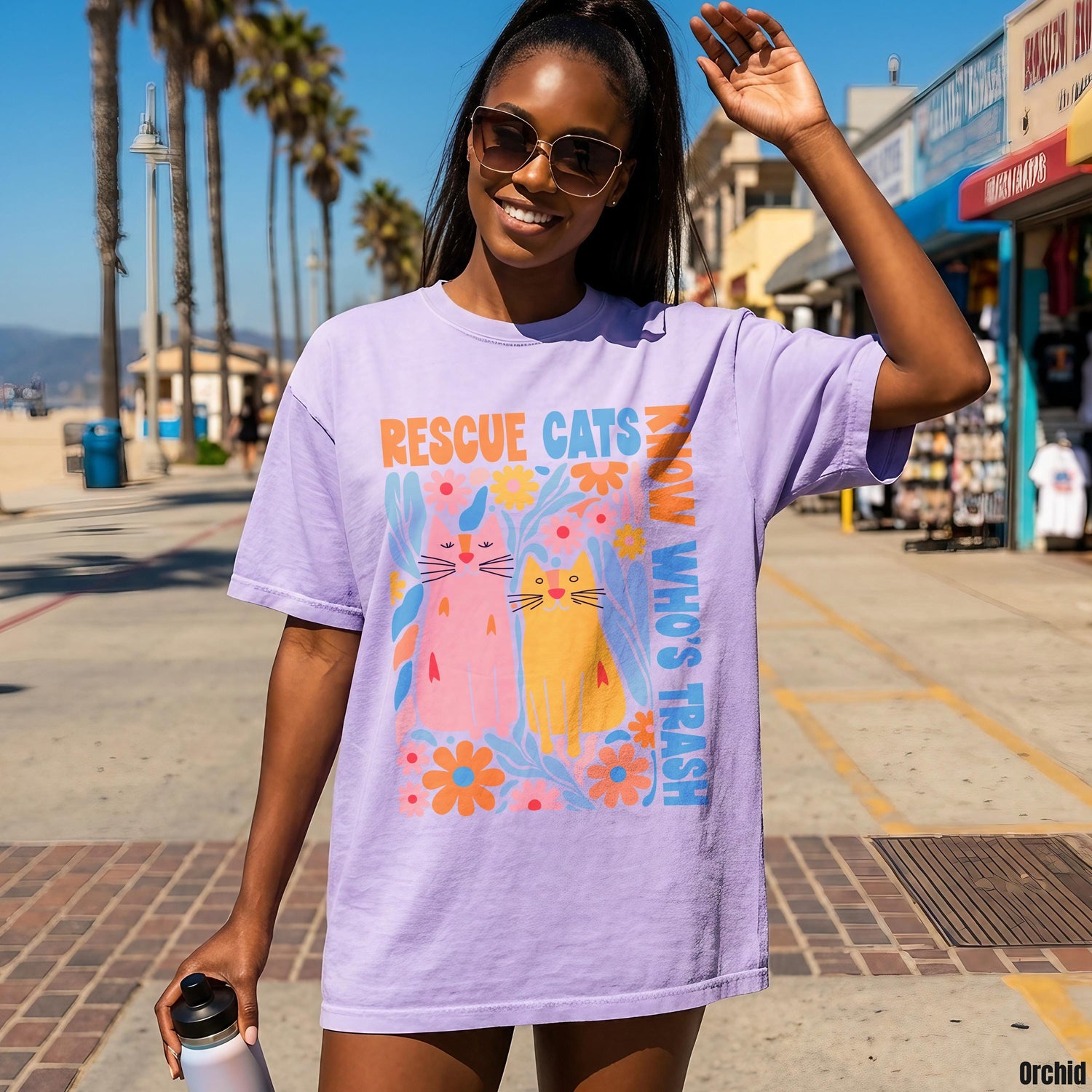 Woman wearing purple t-shirt with &amp;quot;Rescue Cats Know Who&amp;