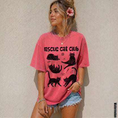 Woman wearing a faded pink t-shirt with &amp;quot;Rescue Cat Club&amp;quot; and cat illustrations.