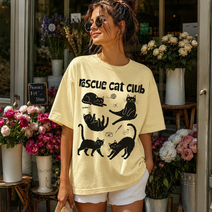 Yellow t-shirt with black cat illustrations and &amp;quot;Rescue cat club&amp;quot; text.
