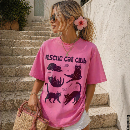 Pink graphic t-shirt with cat illustrations and &amp;quot;Rescue Cat Club&amp;quot; text.