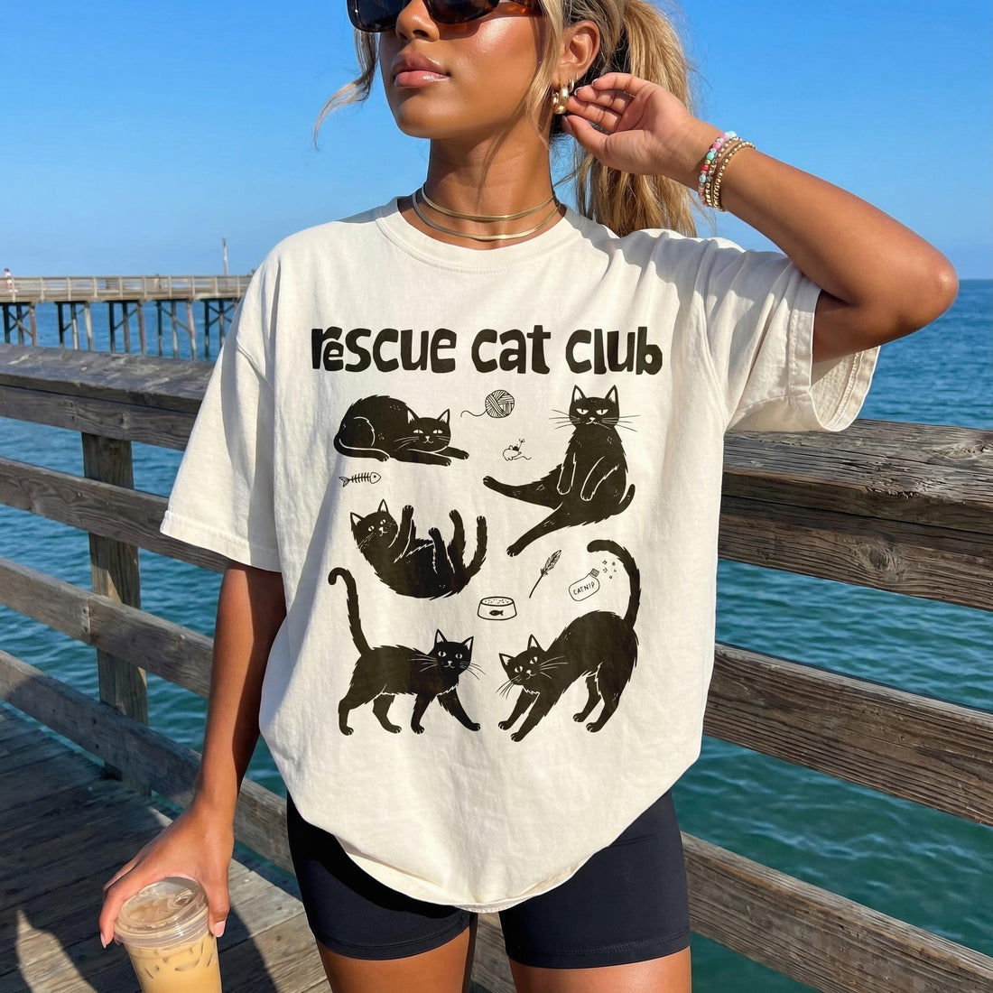 Cream t-shirt with &amp;quot;Rescue Cat Club&amp;quot; text and five black cat illustrations.