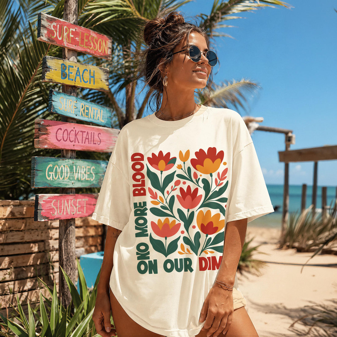Cream t-shirt with floral graphic and &amp;quot;ONO MORE BLOOD ON OUR DIM&amp;quot; text.