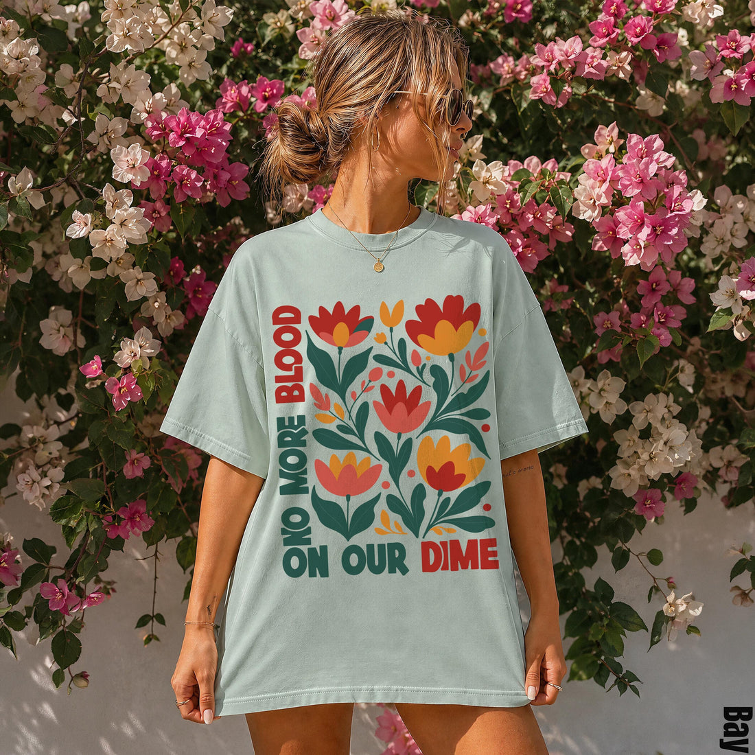 Light blue t-shirt with &amp;quot;NO MORE BLOOD ON OUR DIME&amp;quot; text and floral graphic.