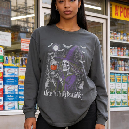 Skeleton witch holding a drink on a dark gray long-sleeved shirt.