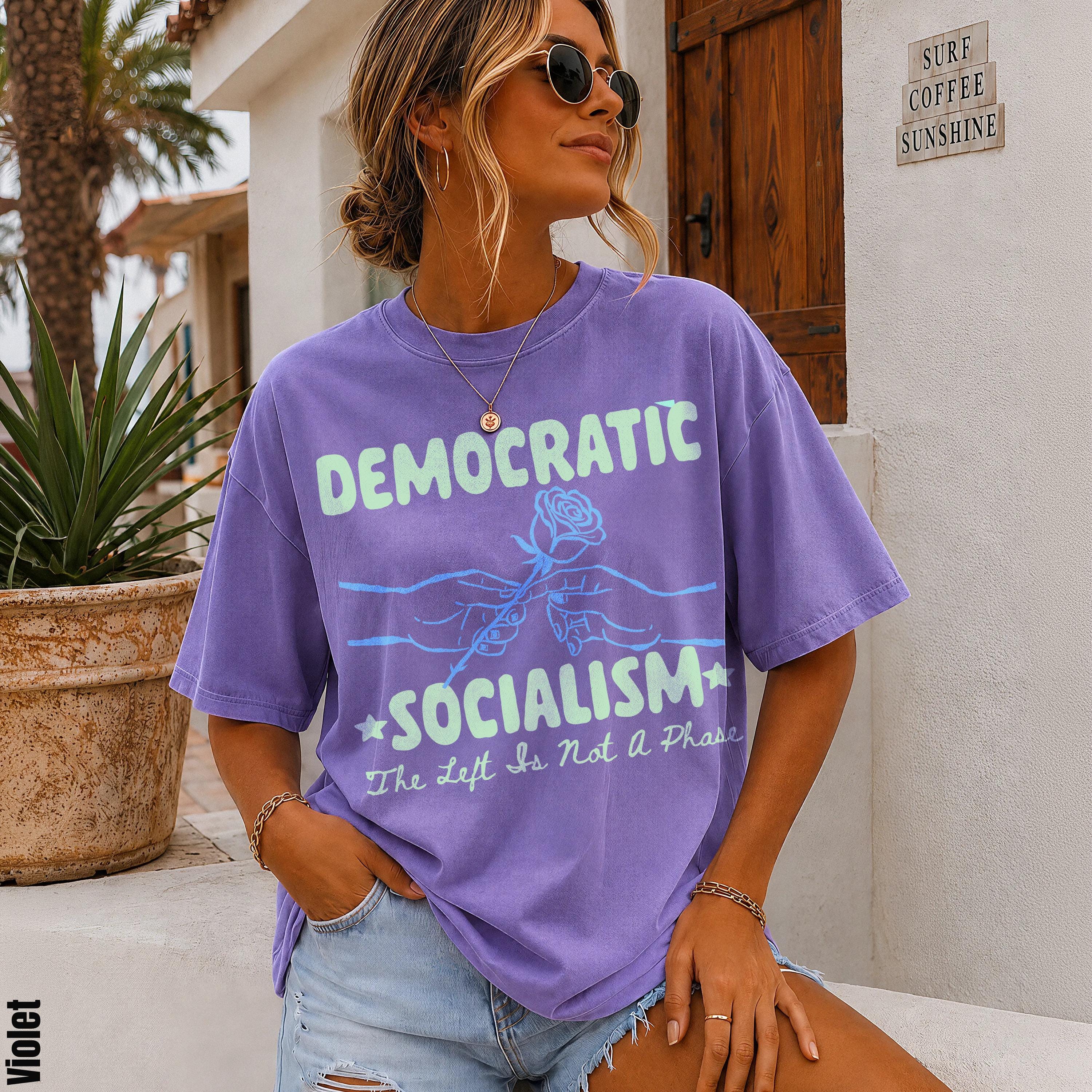Purple t-shirt with &amp;quot;DEMOCRATIC SOCIALISM The Left Is Not A Phase&amp;quot; text.