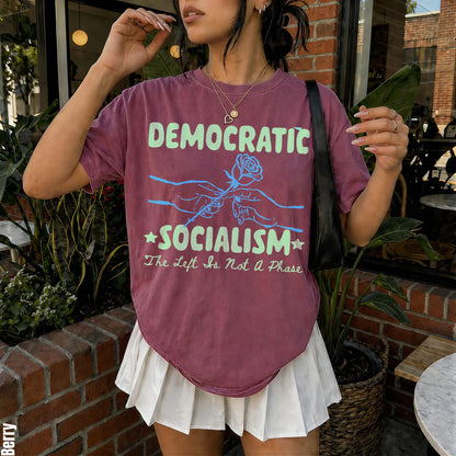 Berry t-shirt with &amp;quot;Democratic Socialism&amp;quot; and rose graphic, subtitle &amp;quot;The Left Is Not A Phase&amp;quot;.