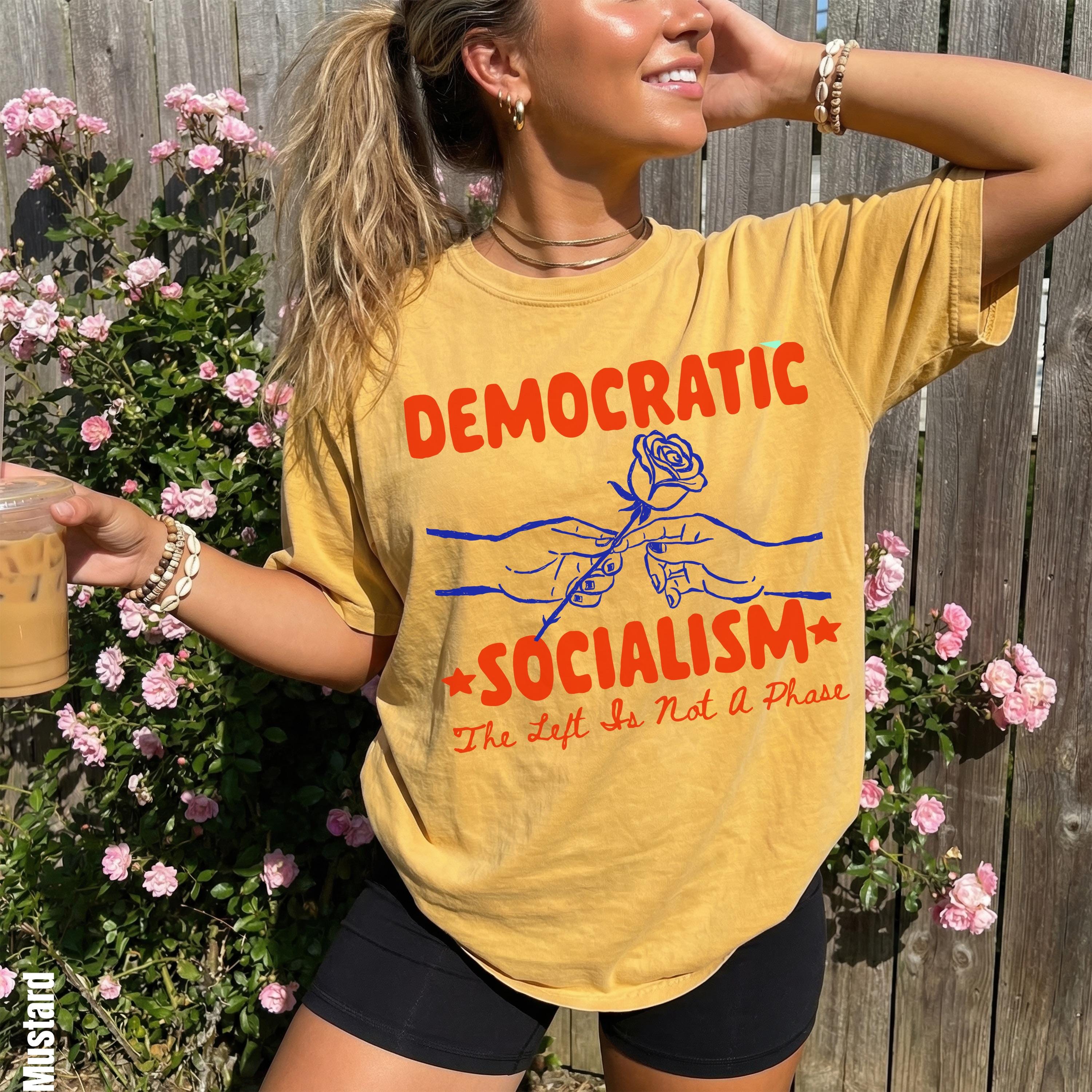 Yellow t-shirt with red text &amp;quot;DEMOCRATIC SOCIALISM&amp;quot; and a rose graphic.