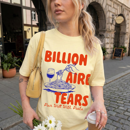 Yellow t-shirt with &amp;quot;Billionaire Tears Pair Well With Pasta&amp;quot; text and spaghetti graphic.
