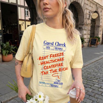 Yellow t-shirt with &amp;quot;Guest Check&amp;quot; design and red text: Rent Freeze, Healthcare, Ceasefire, Tax the Rich, The Donor Class.