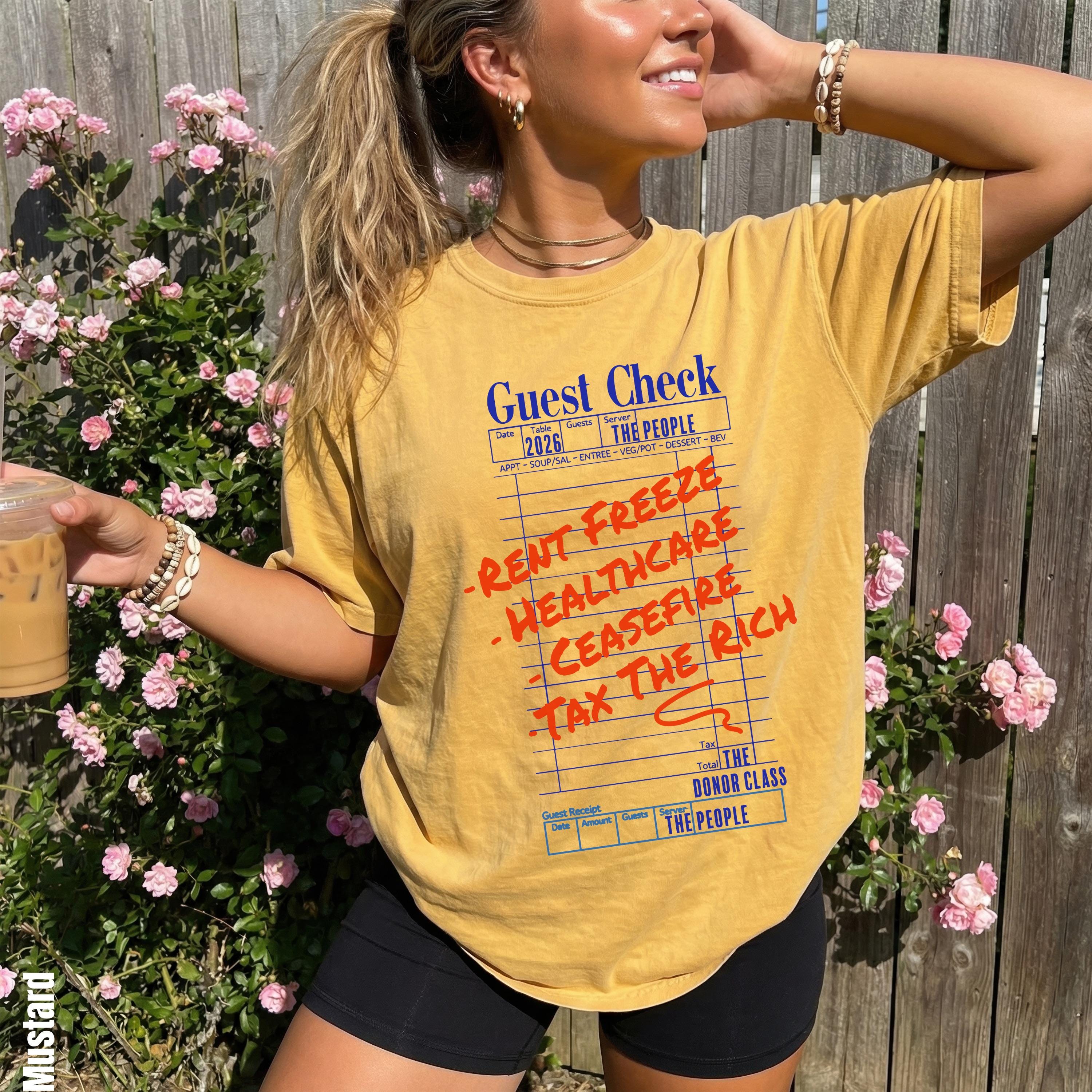 Yellow t-shirt with &amp;quot;Guest Check&amp;quot; and rent/healthcare/tax text, woman holding drink.