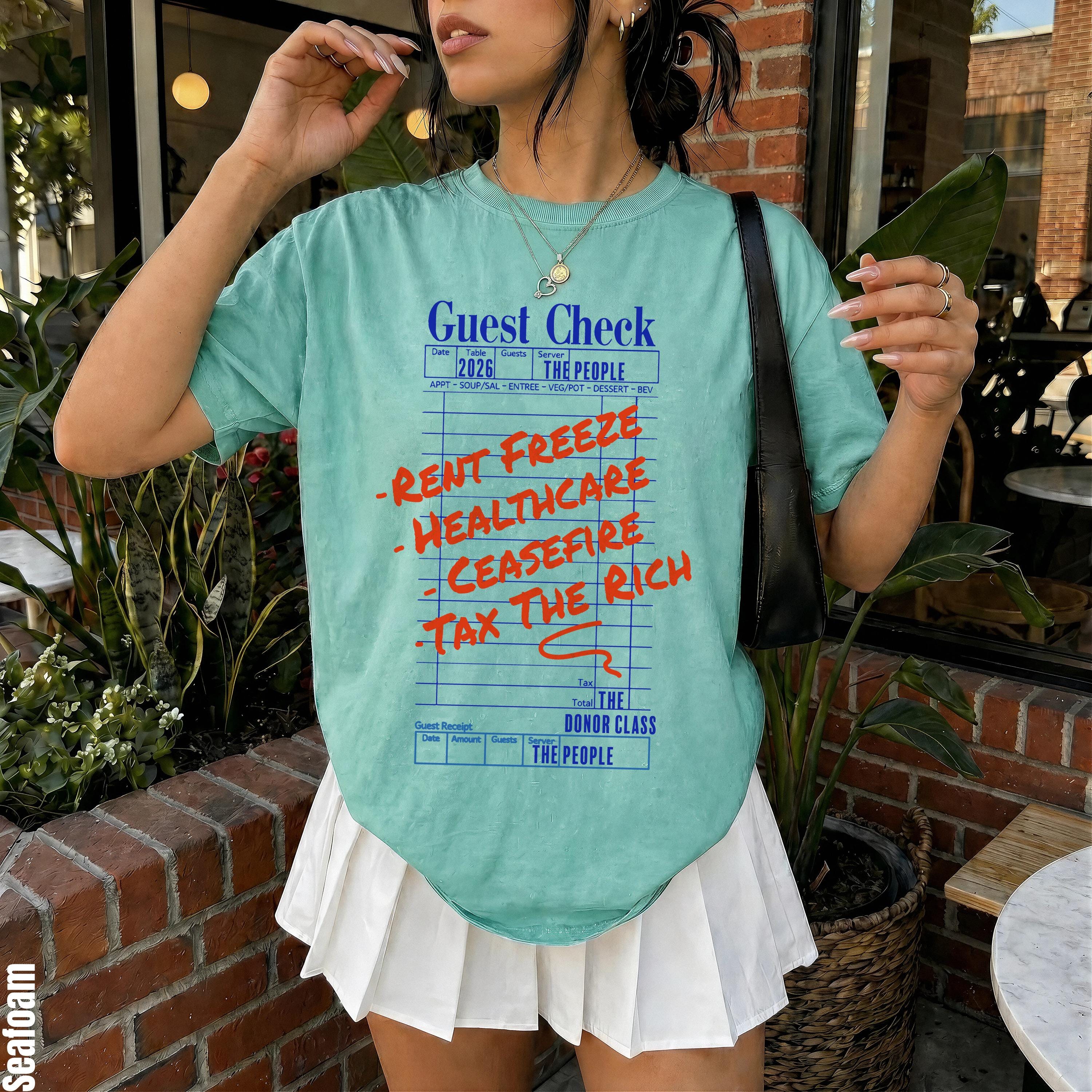 Teal t-shirt with &amp;quot;Guest Check&amp;quot; print: rent freeze, healthcare, ceasefire, tax the rich.