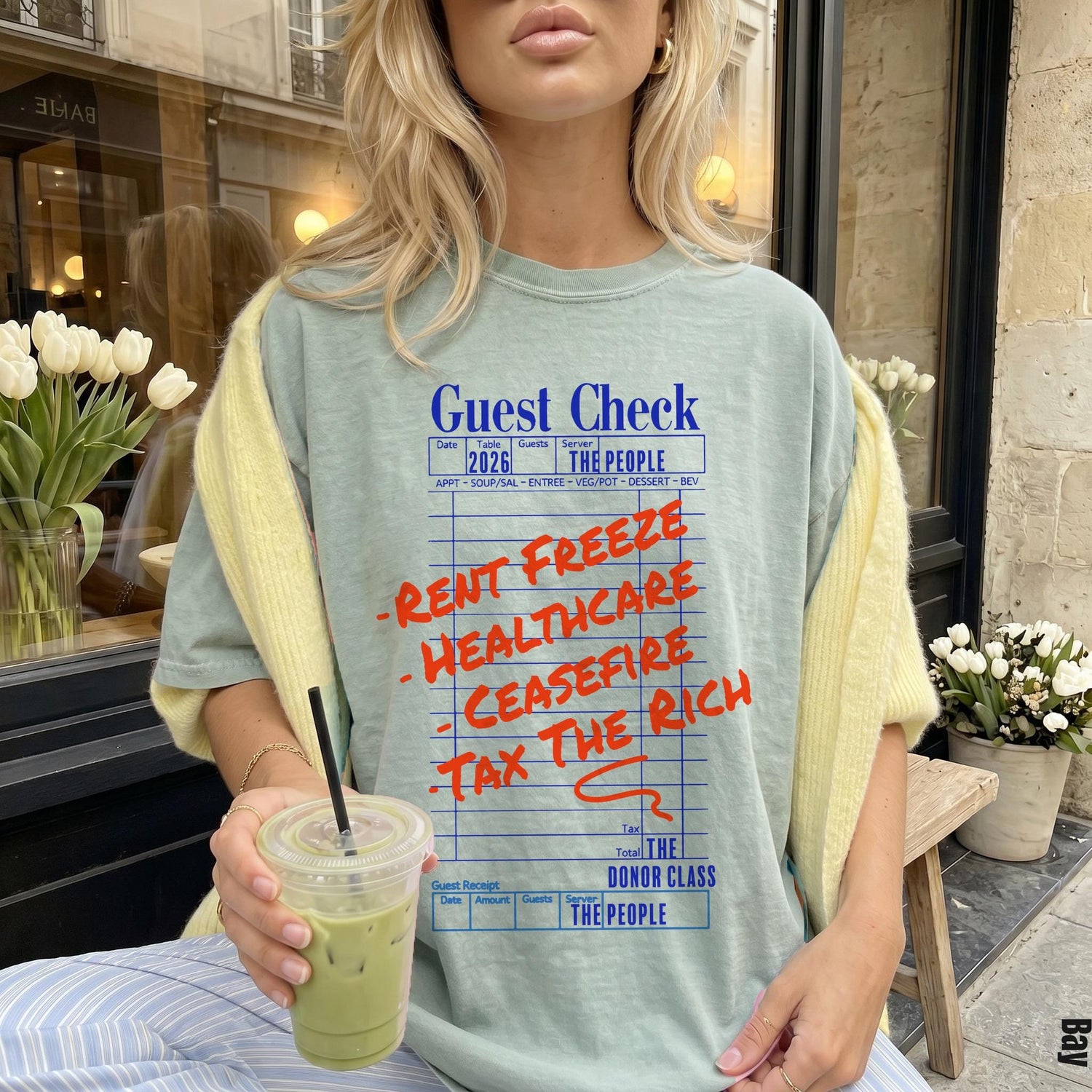 Light blue t-shirt with &amp;quot;Guest Check&amp;quot; design featuring political slogans.