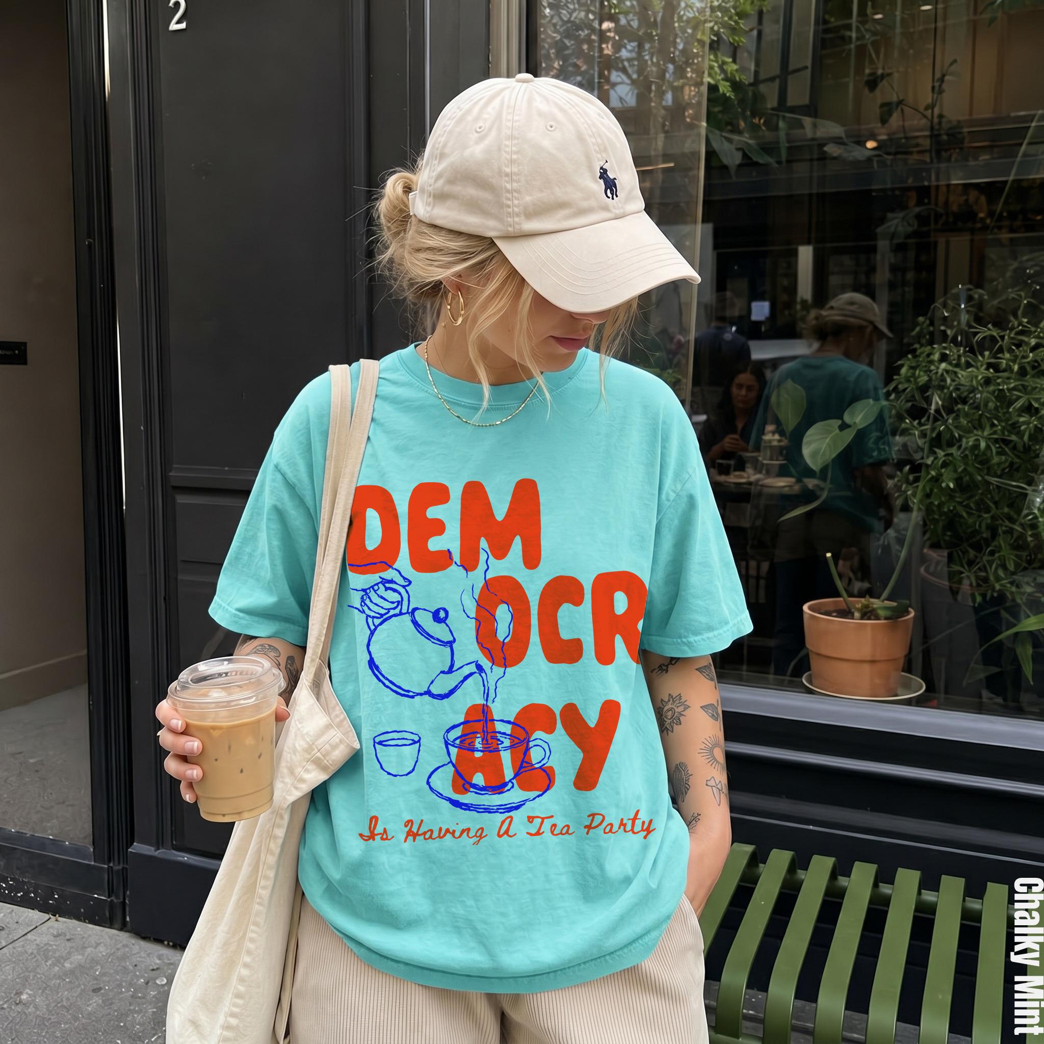 Teal t-shirt with graphic text &amp;quot;DEMOCRACY Is Having A Tea Party&amp;quot; and kettle.