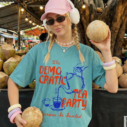 T-shirt with &amp;quot;Democratic Tea Party&amp;quot; graphic and &amp;quot;Everyone Is Invited&amp;quot; text, woman holds coconuts.