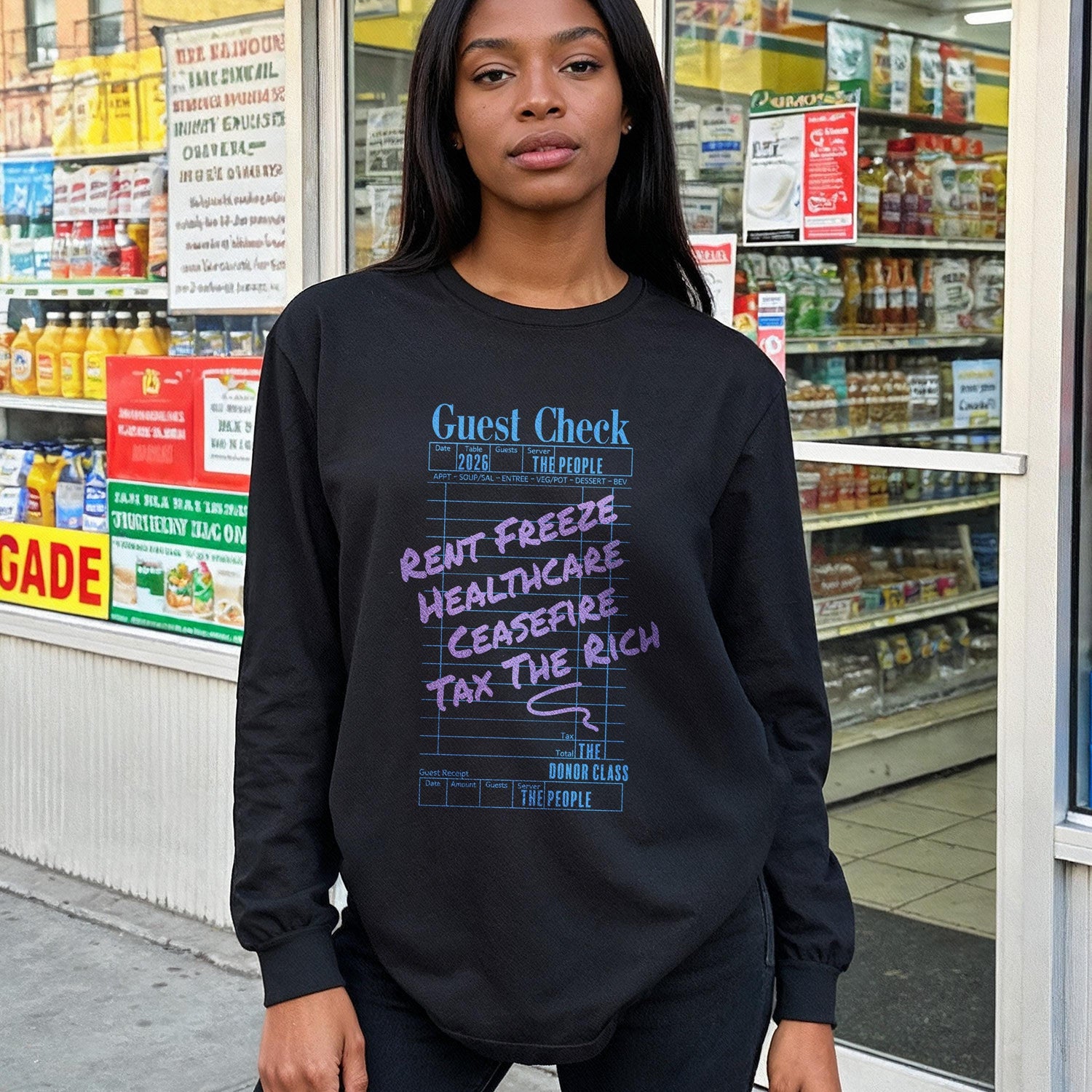 Black long-sleeve shirt with &amp;quot;Guest Check&amp;quot; and political slogans like &amp;quot;Rent Freeze&amp;quot; and &amp;quot;Tax The Rich&amp;quot;.