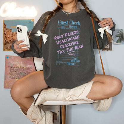 Gray sweatshirt with &amp;quot;Guest Check&amp;quot; graphic listing &amp;quot;Rent Freeze, Healthcare, Ceasefire, Tax The Rich.&amp;quot;