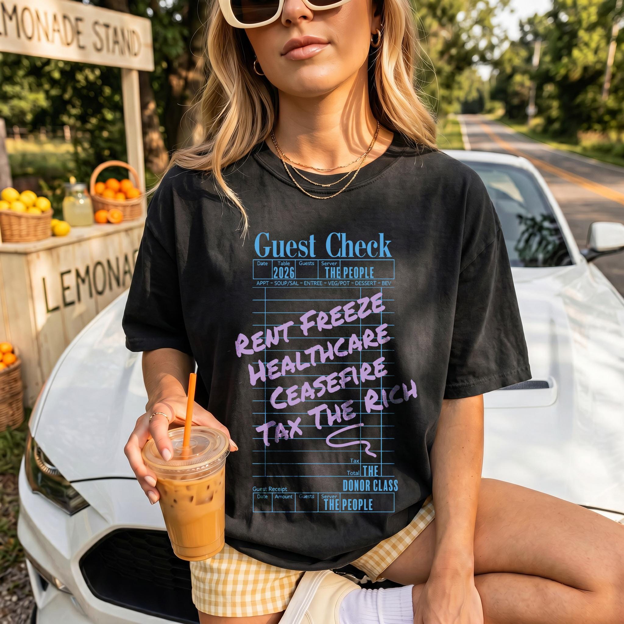 T-shirt with &amp;quot;Guest Check&amp;quot; graphic listing &amp;quot;Rent Freeze,&amp;quot; &amp;quot;Healthcare,&amp;quot; &amp;quot;Ceasefire,&amp;quot; and &amp;quot;Tax the Rich.&amp;quot;