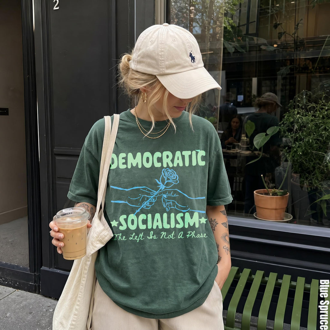 Green t-shirt with &amp;quot;Democratic Socialism&amp;quot; and a rose graphic, worn by a woman.