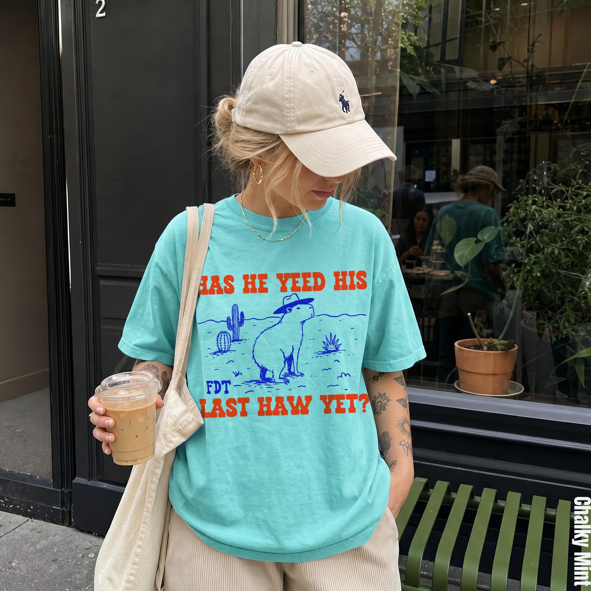 Teal t-shirt with &amp;quot;HAS HE YEED HIS LAST HAW YET?&amp;quot; text and desert graphic.