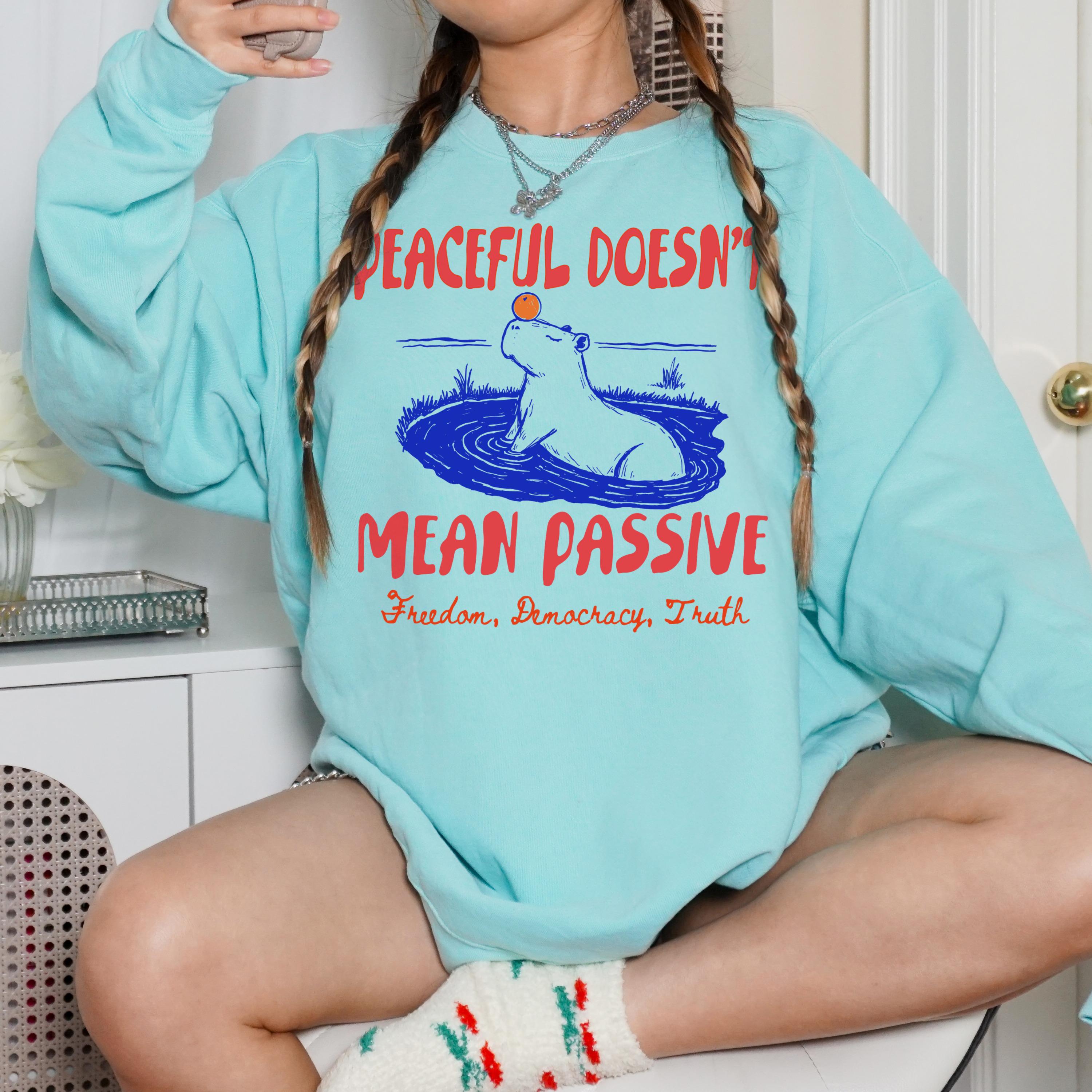 Light blue sweatshirt with a capybara graphic and text &amp;quot;Peaceful Doesn&amp;