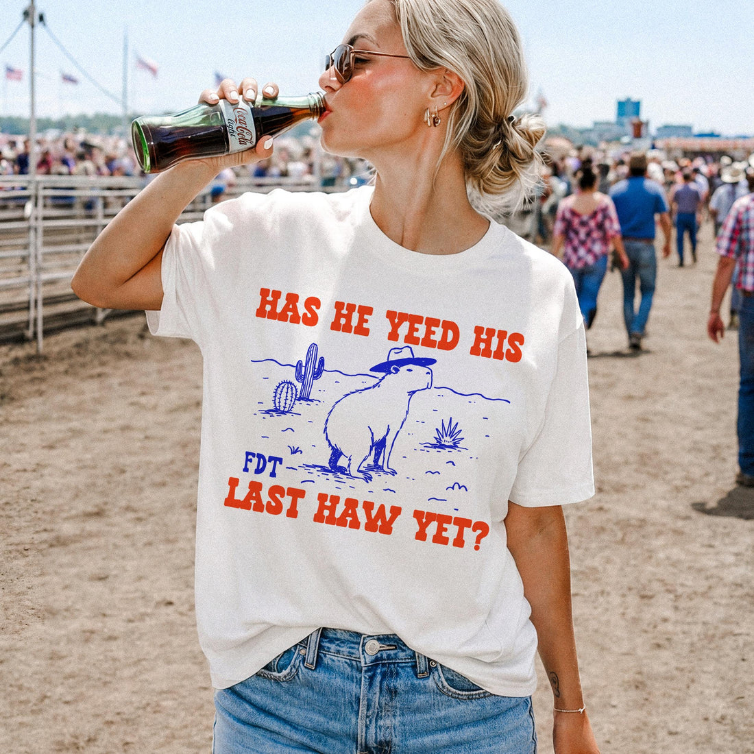 White t-shirt with blue and red graphic and text &amp;quot;HAS HE YEED HIS FDT LAST HAW YET?&amp;quot;.
