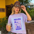 Purple t-shirt with capybara graphic and text: "Cozy Little Socialist."