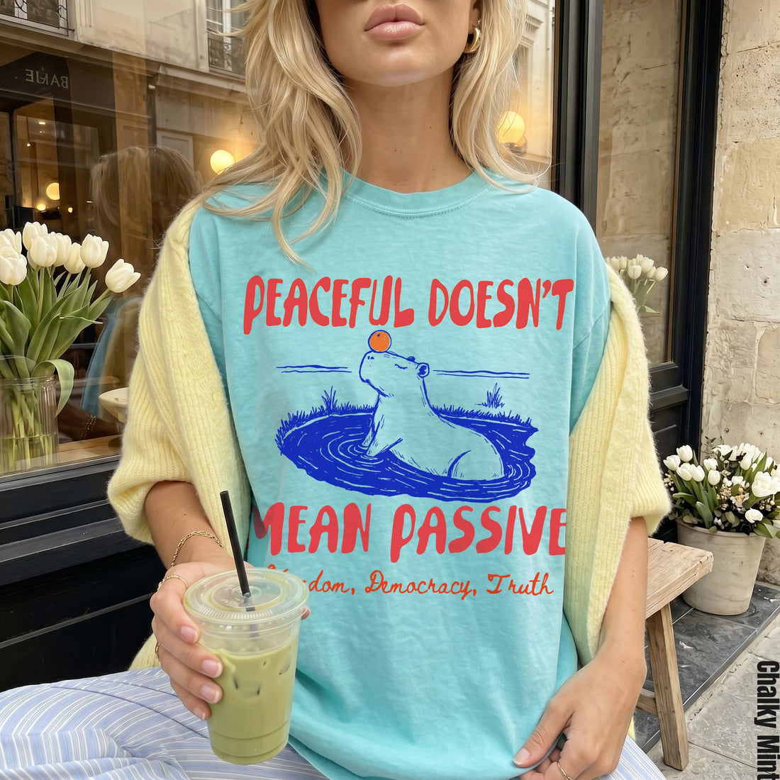 Aqua t-shirt with graphic of capybara in water and text &amp;quot;Peaceful Doesn&amp;