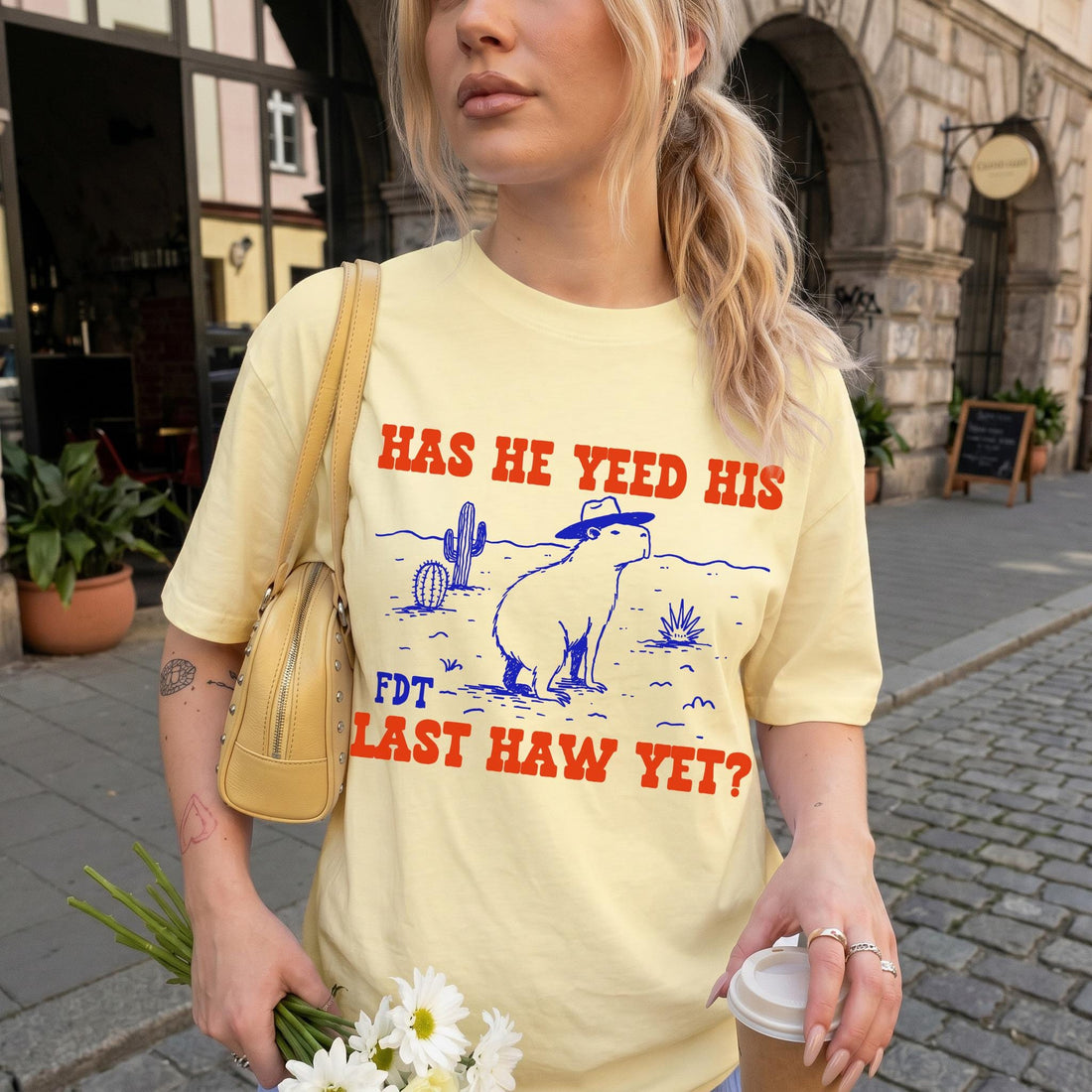 Light yellow t-shirt with &amp;quot;HAS HE YEED HIS FDT LAST HAW YET?&amp;quot; text and capybara graphic.