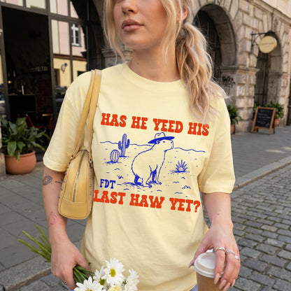 Light yellow t-shirt with &amp;quot;HAS HE YEED HIS FDT LAST HAW YET?&amp;quot; text and capybara graphic.