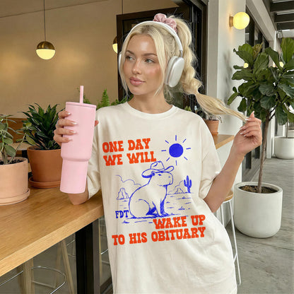 Cream t-shirt with graphic: &amp;quot;ONE DAY WE WILL WAKE UP TO HIS OBITUARY.&amp;quot;