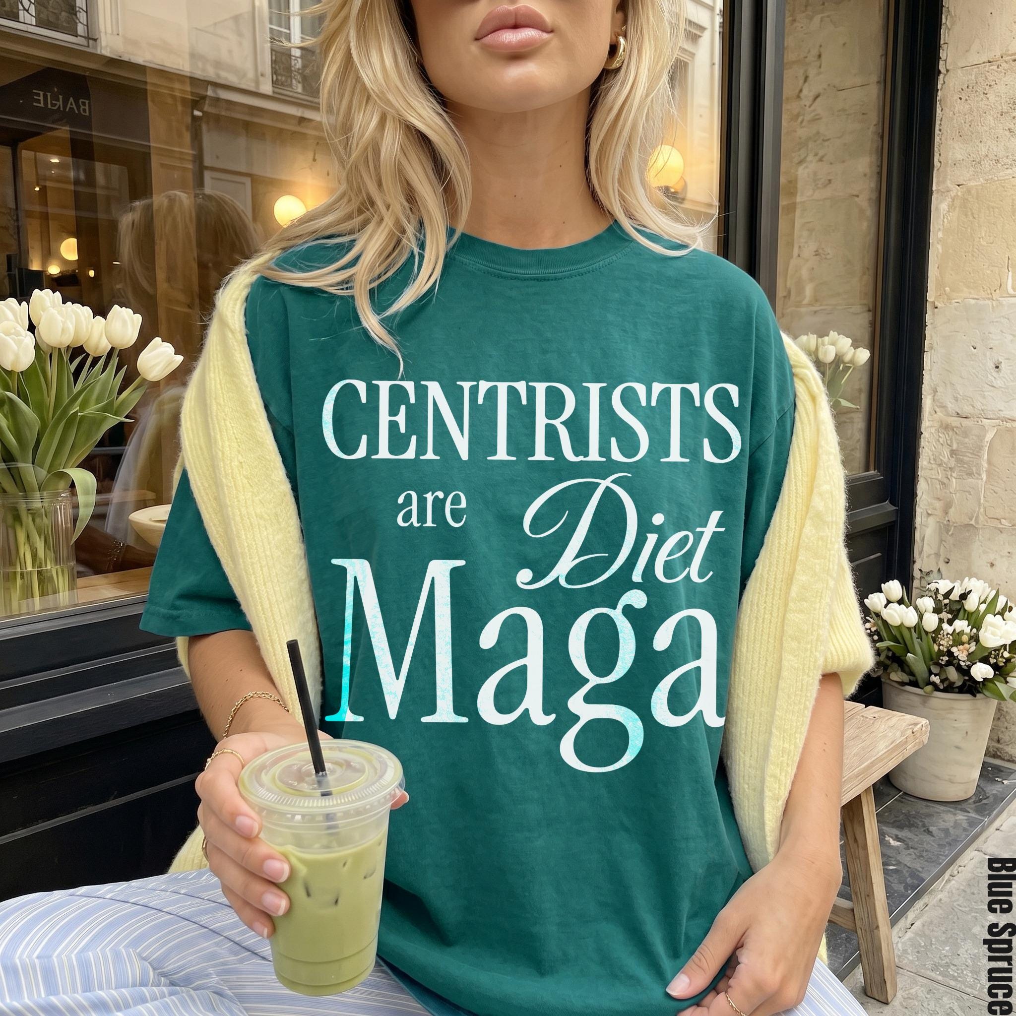 Green t-shirt with &amp;quot;Centrists are Diet Maga&amp;quot; text, held by a person with a drink.