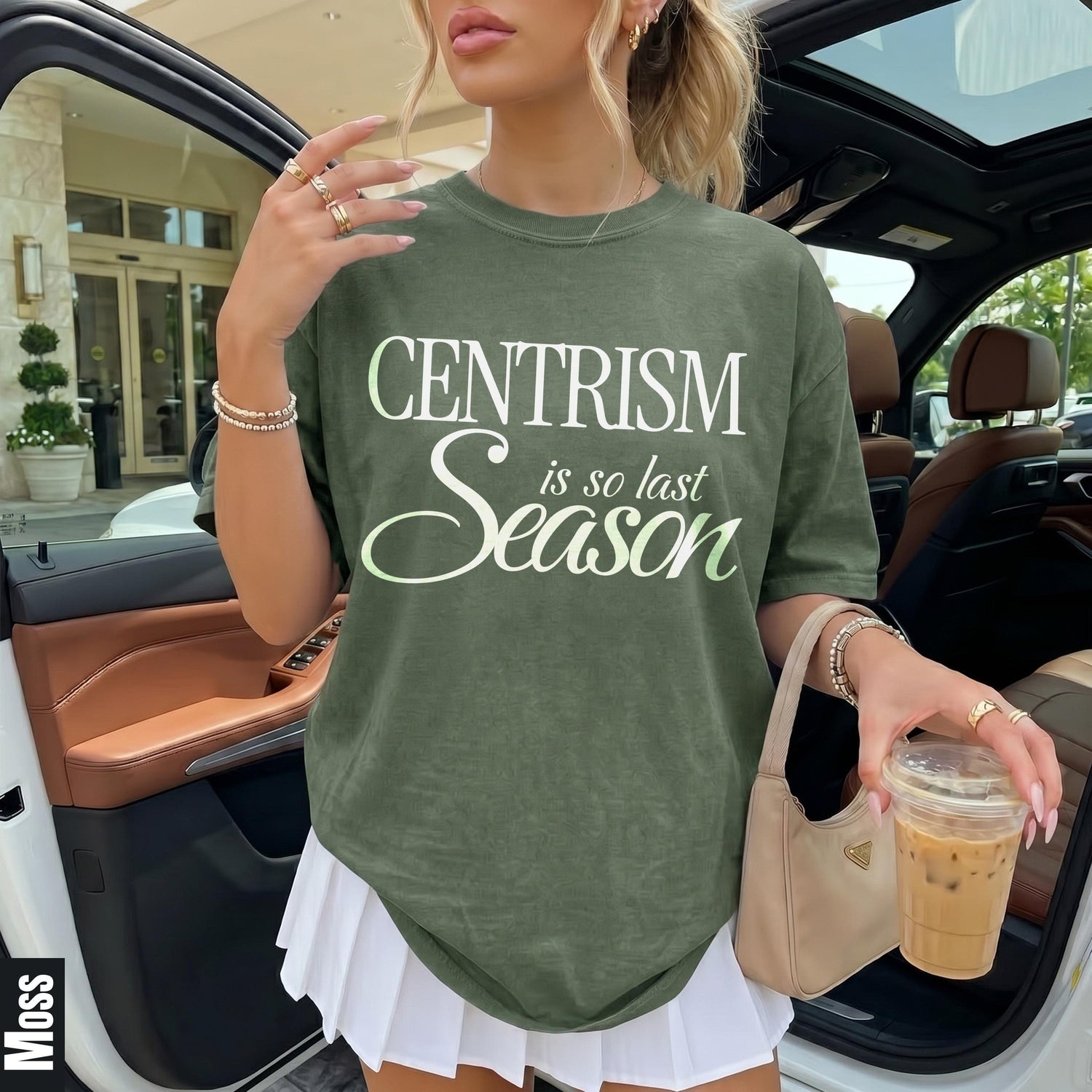 Green t-shirt with &amp;quot;CENTRISM is so last Season&amp;quot; text, holding coffee, wearing white skirt.