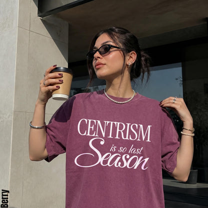 Woman in burgundy t-shirt with &amp;quot;CENTRISM is so last Season&amp;quot; text, holding coffee cup.