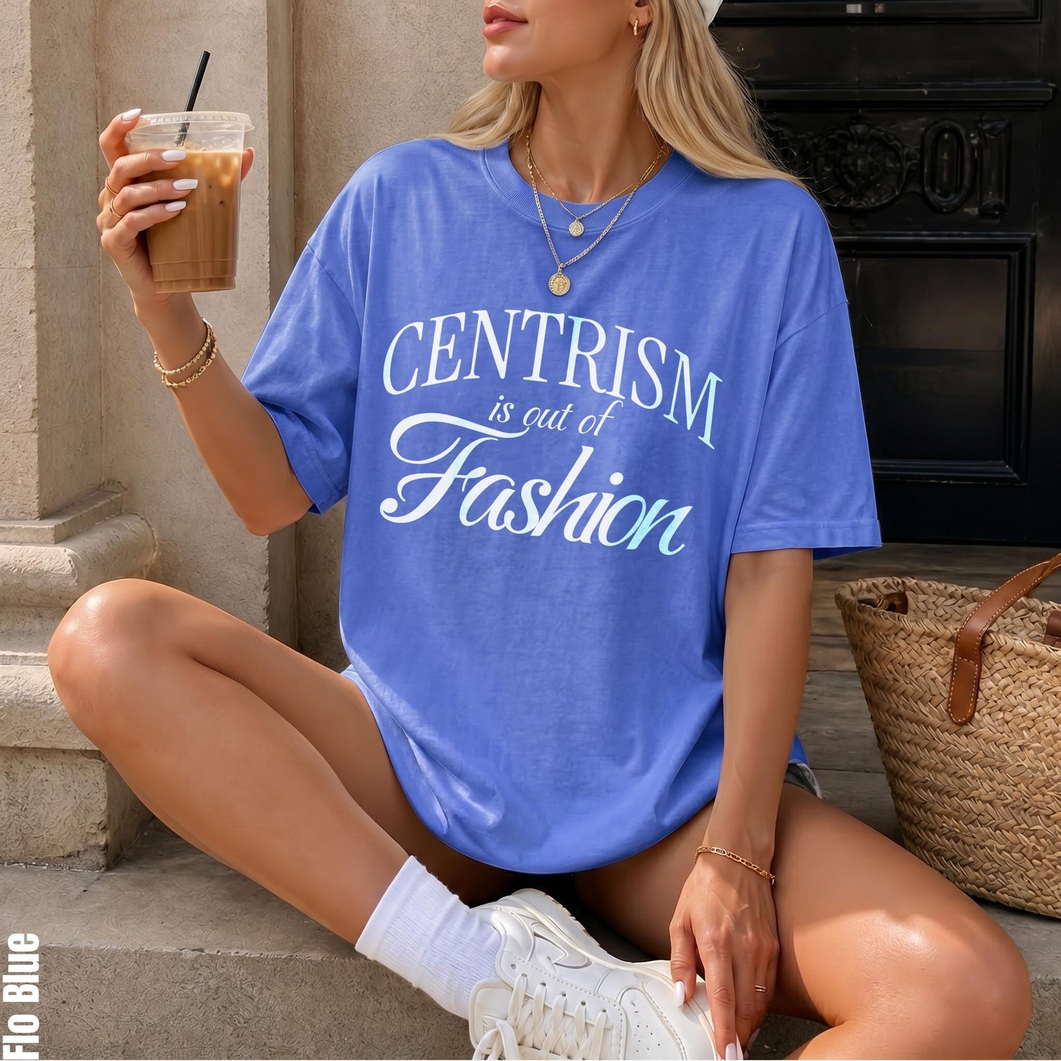 Periwinkle t-shirt with &amp;quot;Centrism is out of Fashion&amp;quot; graphic, holding iced coffee.