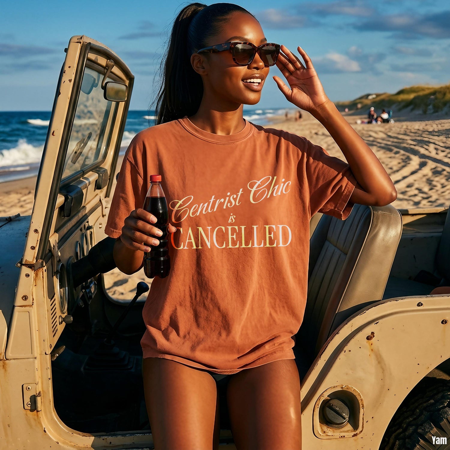 Woman in orange t-shirt with &amp;quot;Centrist Chic is CANCELLED&amp;quot; text, holding a drink by a jeep.